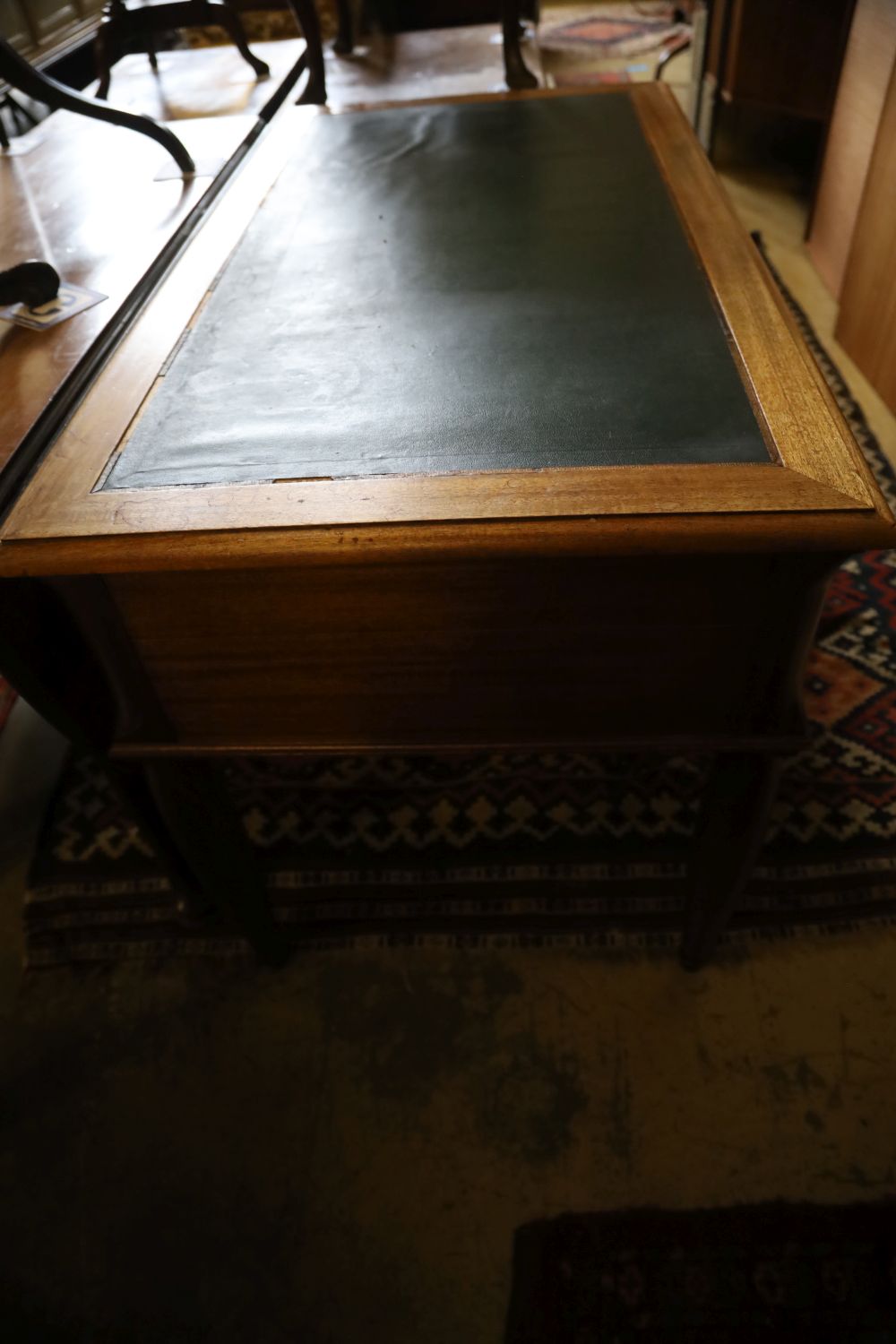 A Continental mahogany writing table, width 120cm, depth 65cm, height 75cm